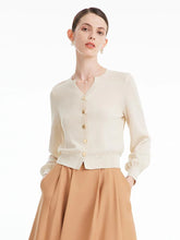 Woman wearing white cardigan and skirt